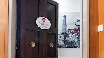 A dark wooden door with a sign that reads "Forever Rooms."