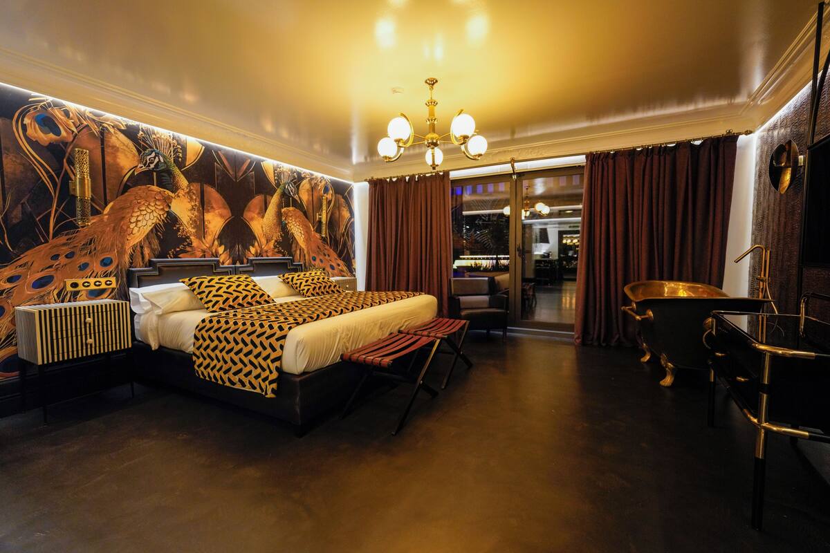 Deluxe Suite, Balcony, Garden View | In-room safe, laptop workspace, blackout drapes, soundproofing