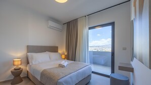 A modern hotel room with a large bed, bedside lamps, a small round ottoman, and a balcony with a city view. - Sokio Attiki Hotel, Bw Premier Collection (Athens)