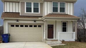 A two-story house with a garage, a front porch, and a mailbox. - Cozy Jersey (Haw River)