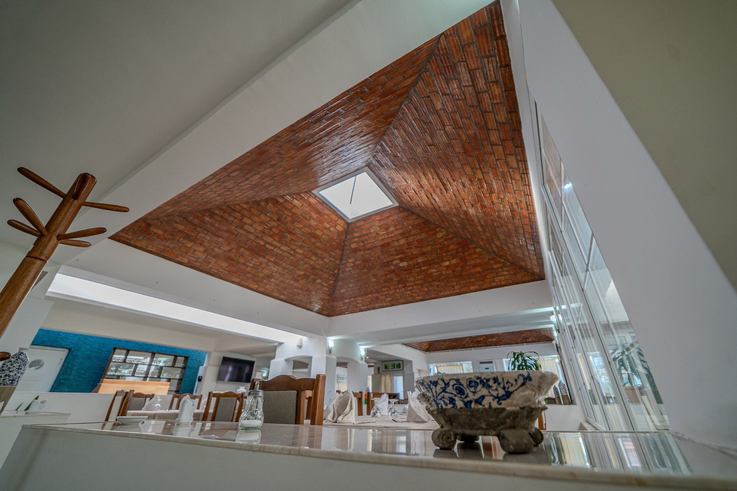 A spacious interior with a high ceiling, a skylight, and a modern kitchen area.