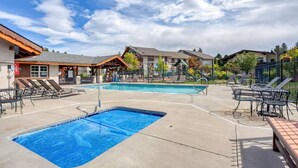 A swimming pool area with lounge chairs and a covered seating area. - GroundFloor+Pool+King Bed+HotTub+Skiing (Leavenworth)