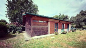 A single-story house with a garage, a front porch, and a small garden area.