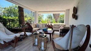 A spacious living area with a large sofa set, a wooden coffee table, and a lounge chair. - Cloud Nine by Alara | Luxury Private Pool & Garden Villa (İstanbul)