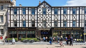 A building with a traditional facade, featuring a market entrance and a café. - The AVON Hotel (Blackpool)