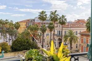 A coastal cityscape with palm trees, historic buildings, and a clear sky. - Experience Hyères on foot from this beautiful, central apartment. (Hyères)