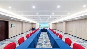 A conference room with a long table, red chairs, and a carpeted floor. - Tai'an Shanhai Hotel (Tianwaicun) (Tai'an)