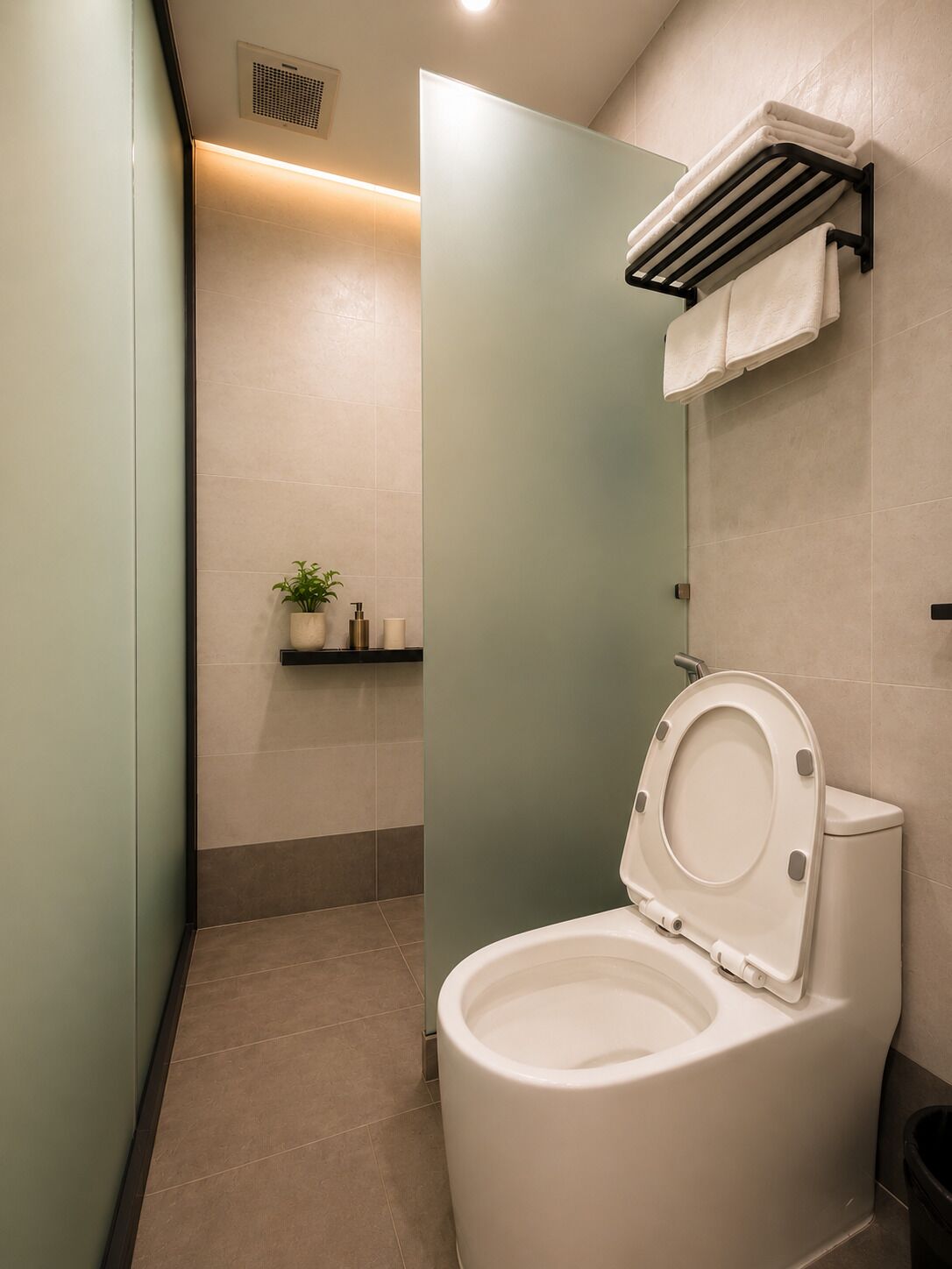 Un baño moderno con inodoro, toallero y estante con artículos de aseo.