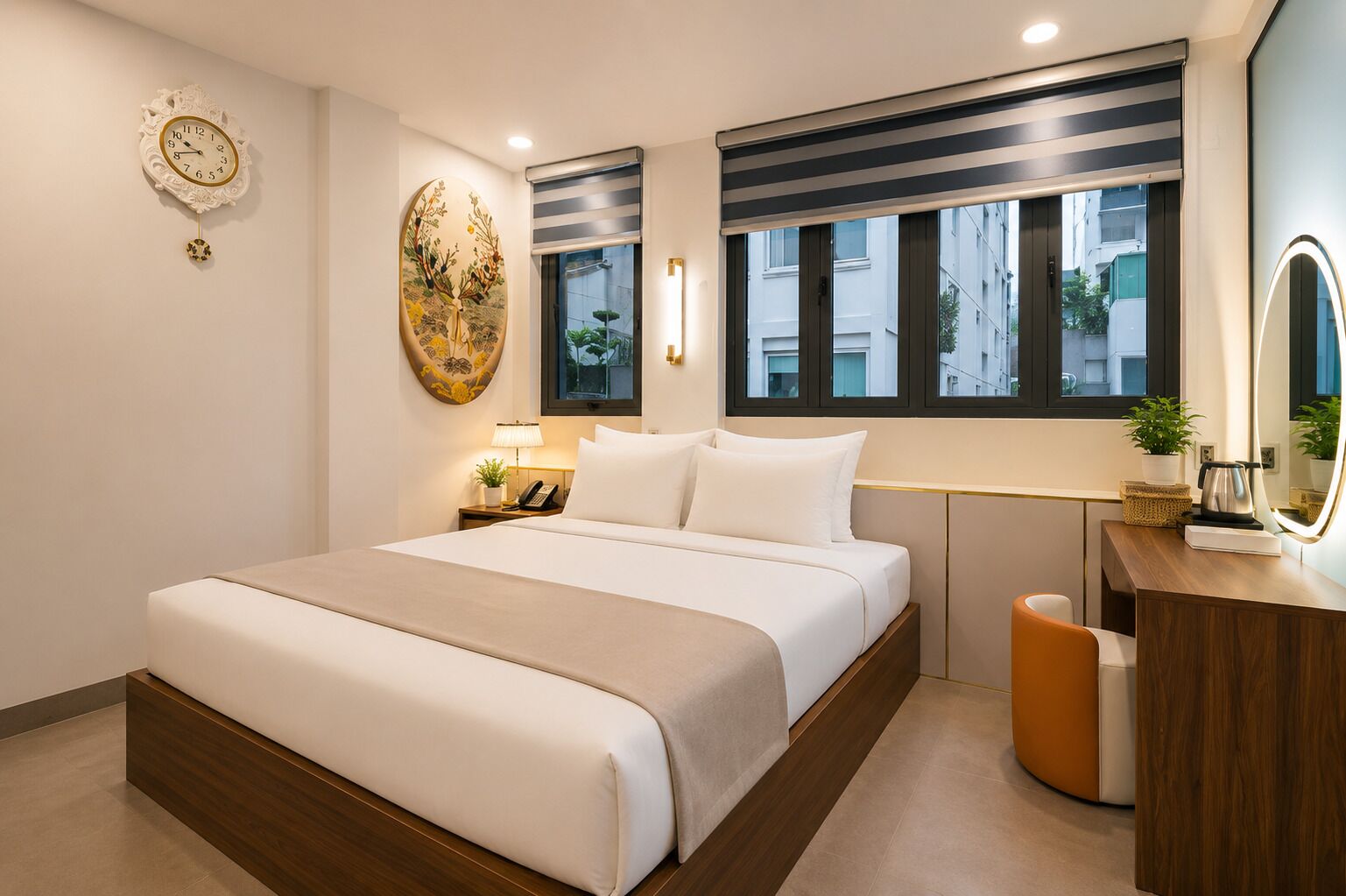 A modern hotel room with a large bed, bedside table with a lamp, a decorative wall clock, a window with a view of buildings, and a wooden dresser with a mirror.