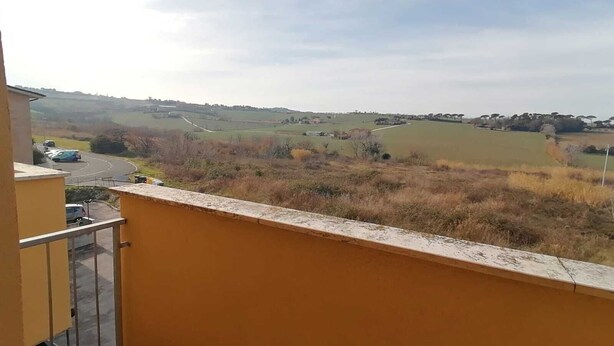 A balcony with a view of a rural landscape, including fields and distant buildings. - Cleo Dalia (Ancona)