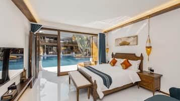 A modern hotel room with a large bed, a bench, a TV, and a view of a swimming pool.
