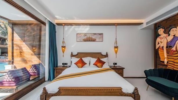 A bedroom with a large bed, a window with a view of a pool, and a painting on the wall. - Jinghong Manying Dai Tai Courtyard Villa (Jinghong)