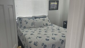 A bedroom with a bed, a ceiling fan, a window with blinds, and a framed picture on the wall. - Lagoon Life, Beach Please! (Stafford Township)