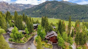 A residential area with houses surrounded by dense forests and mountains in the background. - Cedars at Palisades by Avantstay Hot Tub, Resort Access, and Mountain Views (Olympic Valley)