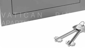 A metallic key with a keyring and a keyhole. - Vatican Pixel Apartments - DOUBLE (Unknown)
