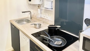 A modern kitchen with a built-in stove, a microwave, and a sink.