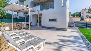 A modern two-story building with a covered outdoor seating area, a pool, and a well-maintained lawn. - Two bedroom cozy apartment in Banjole (Banjole)