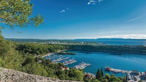 A marina with boats docked, surrounded by greenery and a clear sky. - One bedroom beautiful home in Omisalj (Omisalj)