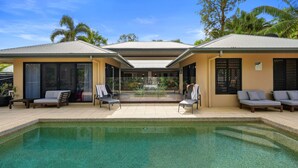 A pool area with lounge chairs and a covered seating area. - The Pavilion at Trinity Beach (Trinity Beach)