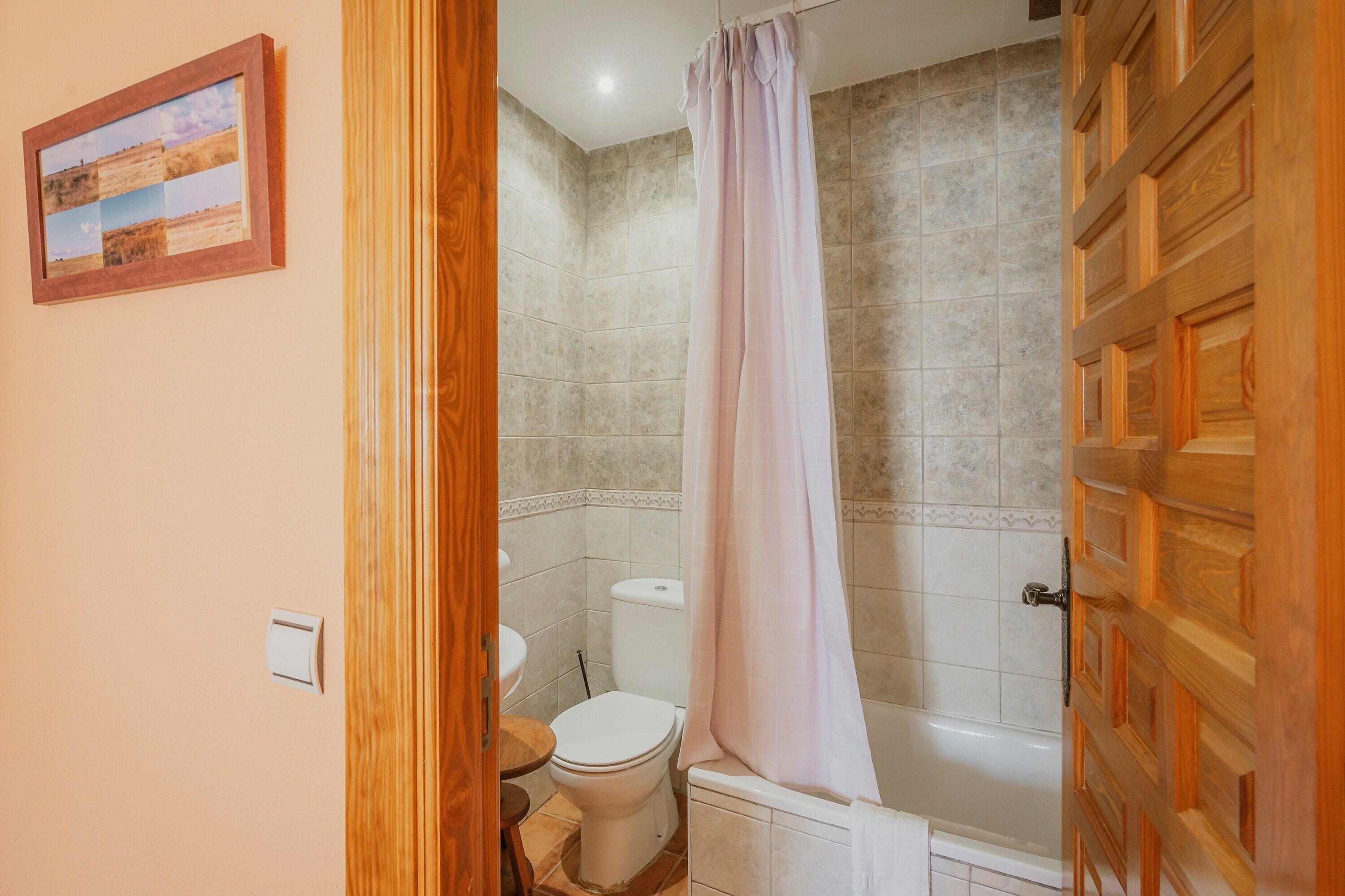 A bathroom with a toilet, shower, and bathtub.