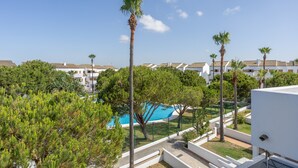 A pool surrounded by trees and buildings.
