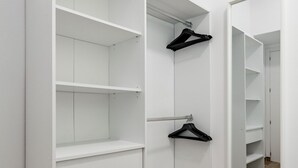 A walk-in closet with white shelving and a full-length mirror. - San Isidro IV - Cozy apartment (Madrid)