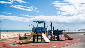 A playground with multiple slides and climbing structures, located near a beach. - Apartment 'Les Balcons De La Méditerranée' with Sea View and Balcony (Narbonne-Plage)