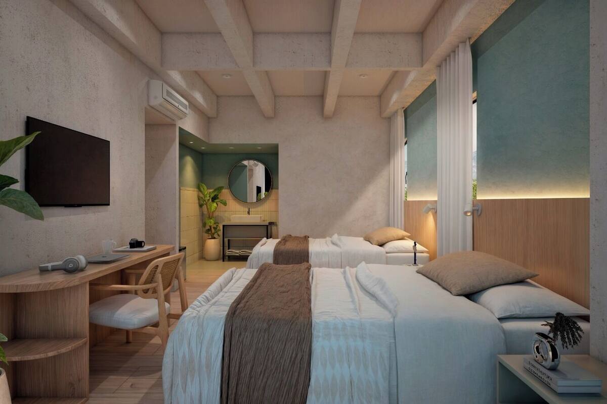 A modern hotel room with a large bed, a desk, and a seating area.