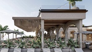 A rooftop lounge area with lounge chairs, palm trees, and a modern architectural design. - La Santa Hotel Boutique (Santa Marta)