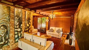 A spacious living room with a high ceiling, wooden beams, and a fireplace. There are two white sofas and a coffee table. - Spectacular Villa only 20min from Bogota - Cota Cundinamarca (Vereda el Abra)