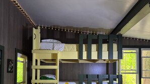 A bunk bed room with a window and string lights. - The Mill Creek Hideout (Mill Creek)
