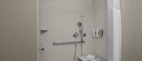 A modern bathroom with a shower, toilet, and sink.