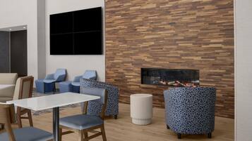 A modern interior with a wooden wall, seating area, and a fireplace.