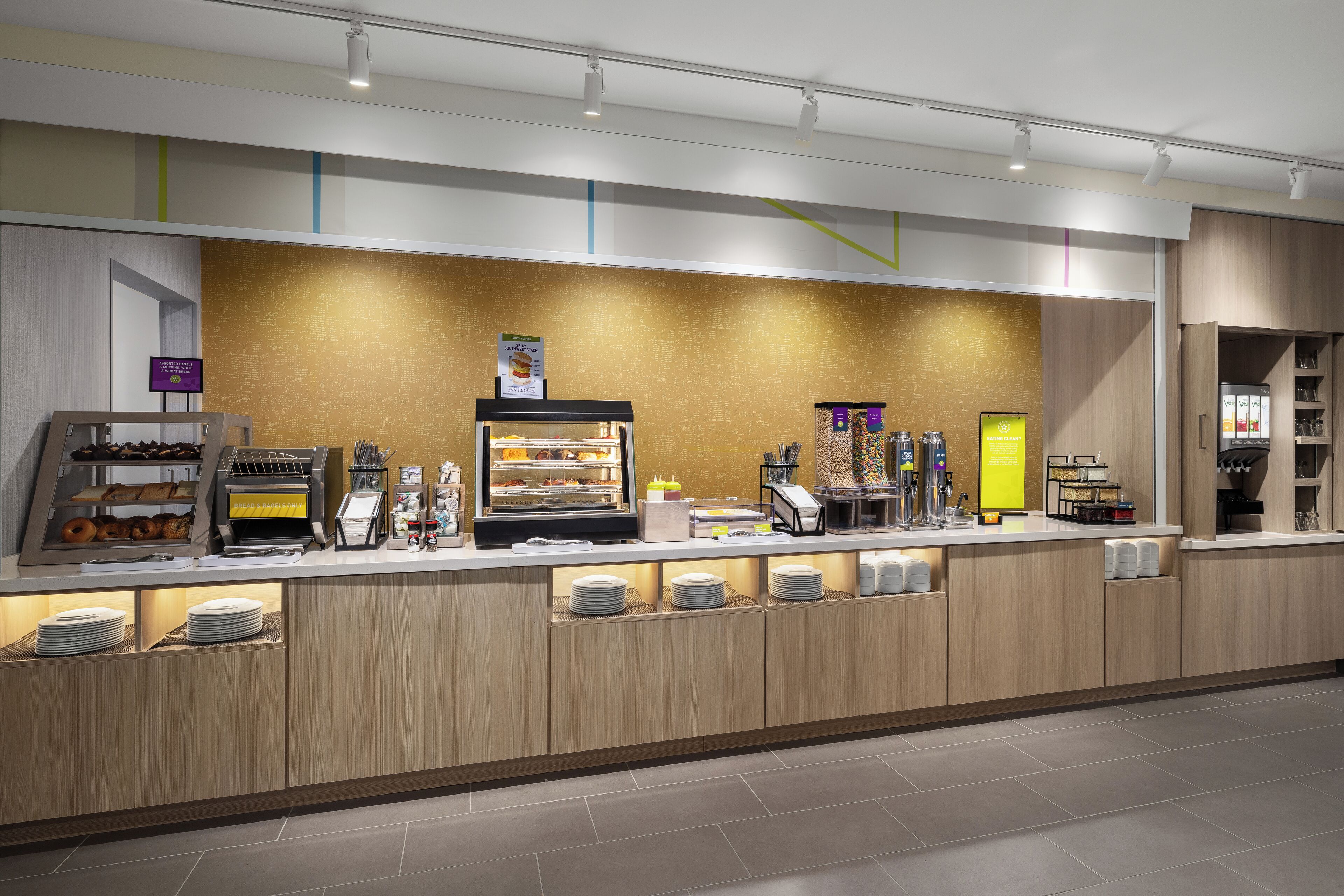 A modern breakfast bar with a variety of food items and a self-service station.