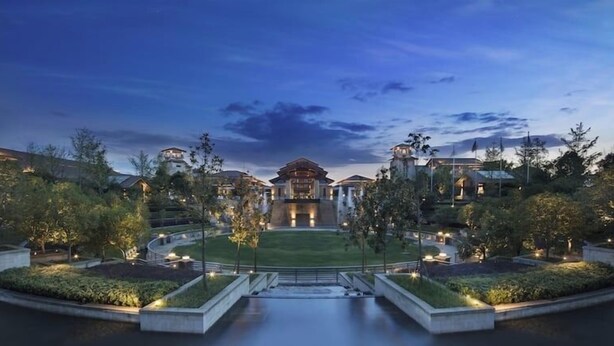 A large, modern hotel with a central courtyard, multiple wings, and a well-maintained landscape. - Hilton Garden Inn Wuhan Optics Valley (Wuhan)