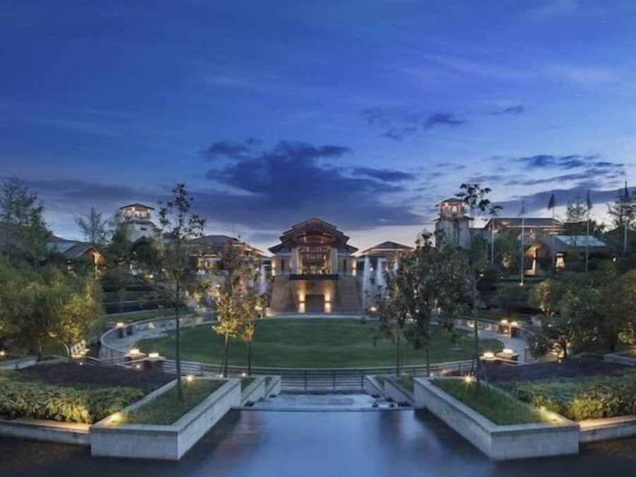 A large, modern hotel with a central courtyard, multiple wings, and a well-maintained landscape.