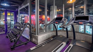 A gym with treadmills, dumbbells, and exercise equipment. - Tru by Hilton Tam Ky City Centre (Da Nang)