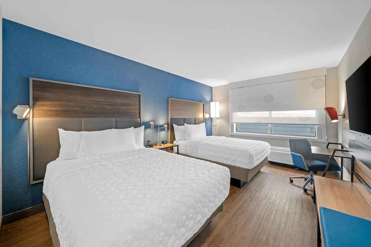 Luxe beddengoed, pillowtop-bedden, een bureau, een laptopwerkplek