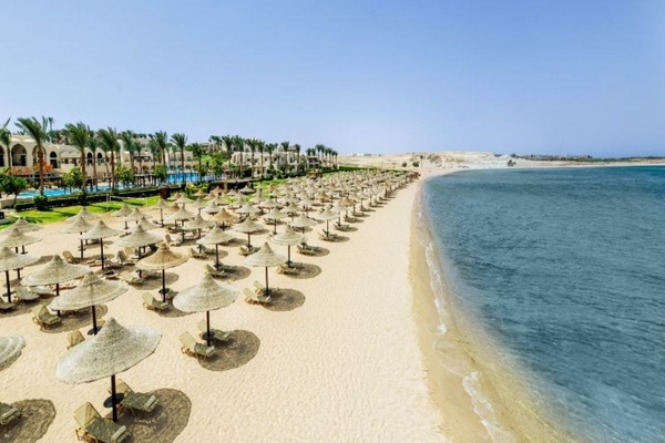 Escape to a sunlit beach with endless loungers and sea views