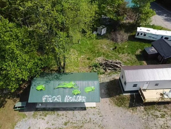 A green-roofed building with a sign reading "FROG HOLLOW."