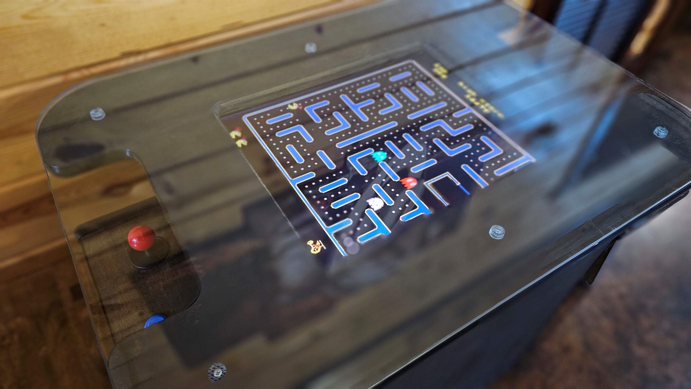 A table with a glass top and a circuit board design underneath.