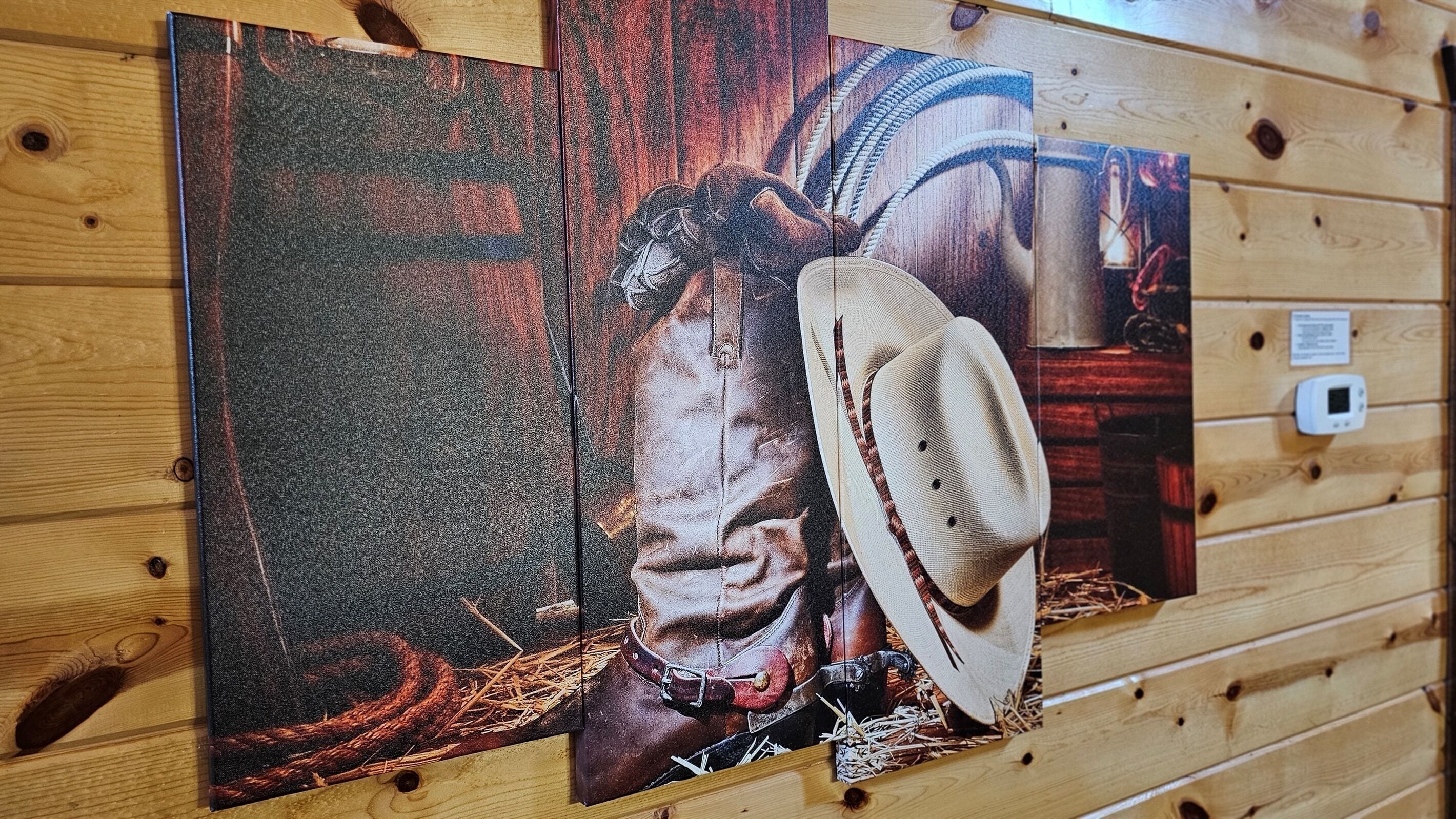 A wooden wall with three framed artworks depicting a cowboy and a horse.