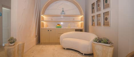 A modern bathroom with a freestanding bathtub, a vanity with a marble countertop, and a wall-mounted mirror.