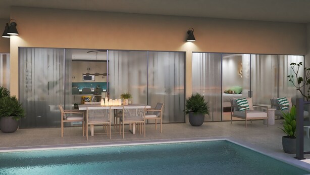 A modern outdoor pool area with a dining table and chairs, surrounded by potted plants and a seating area with cushions.