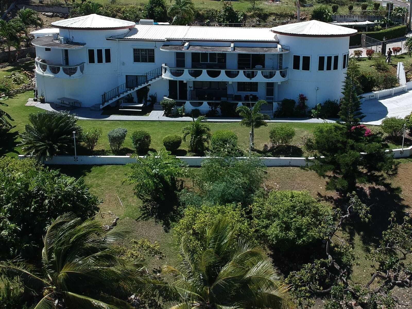 A multi-story building with a symmetrical design, featuring balconies and a central courtyard.