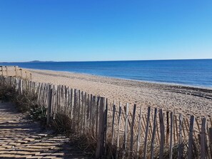A beach with a wooden fence and a clear view of the ocean. - Villa located in a secured residence with pool, for 4 people, at only 400m from the beach of... (PORTIRAGNES)