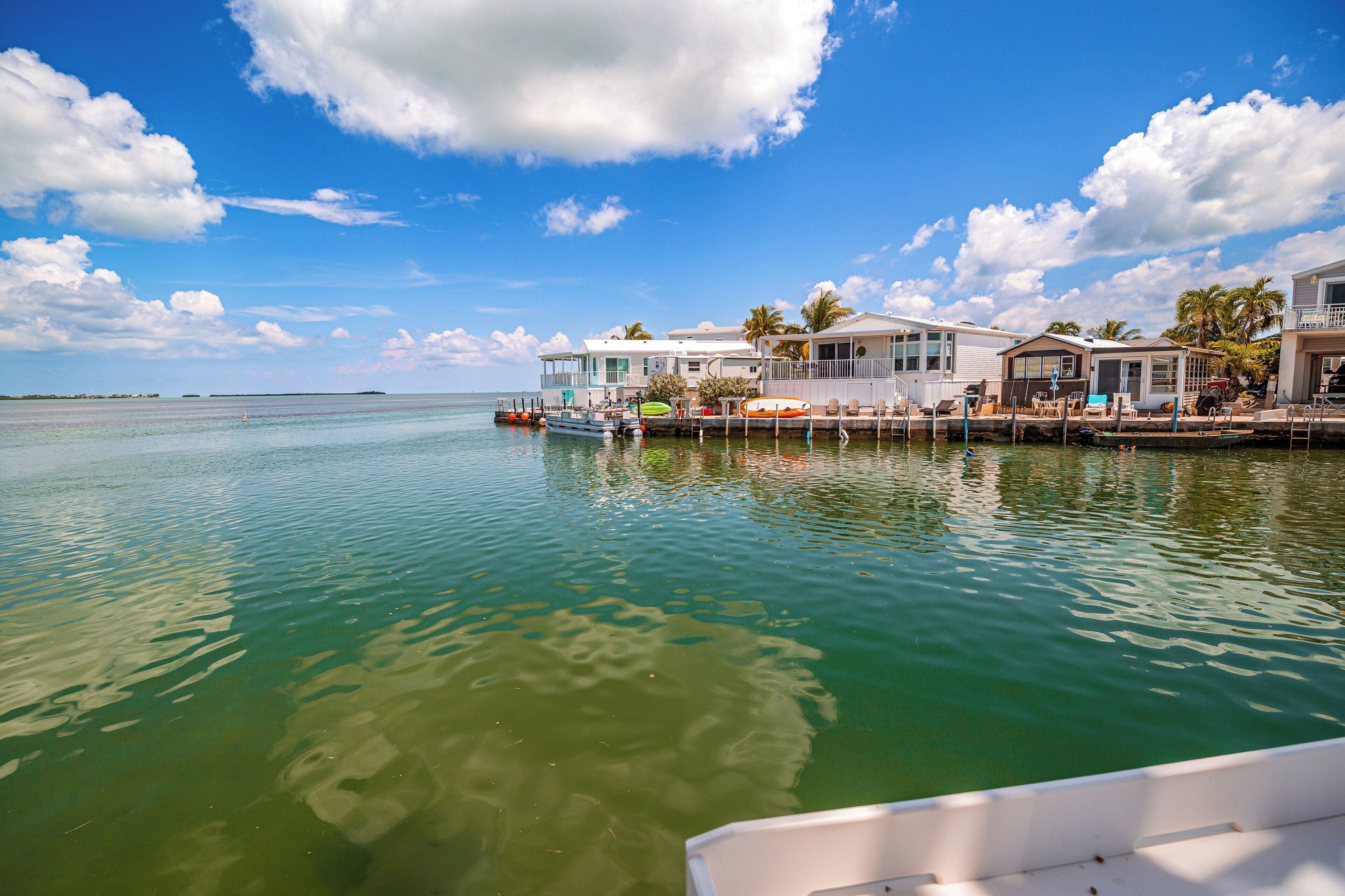 A waterfront property with multiple buildings, docks, and boats.