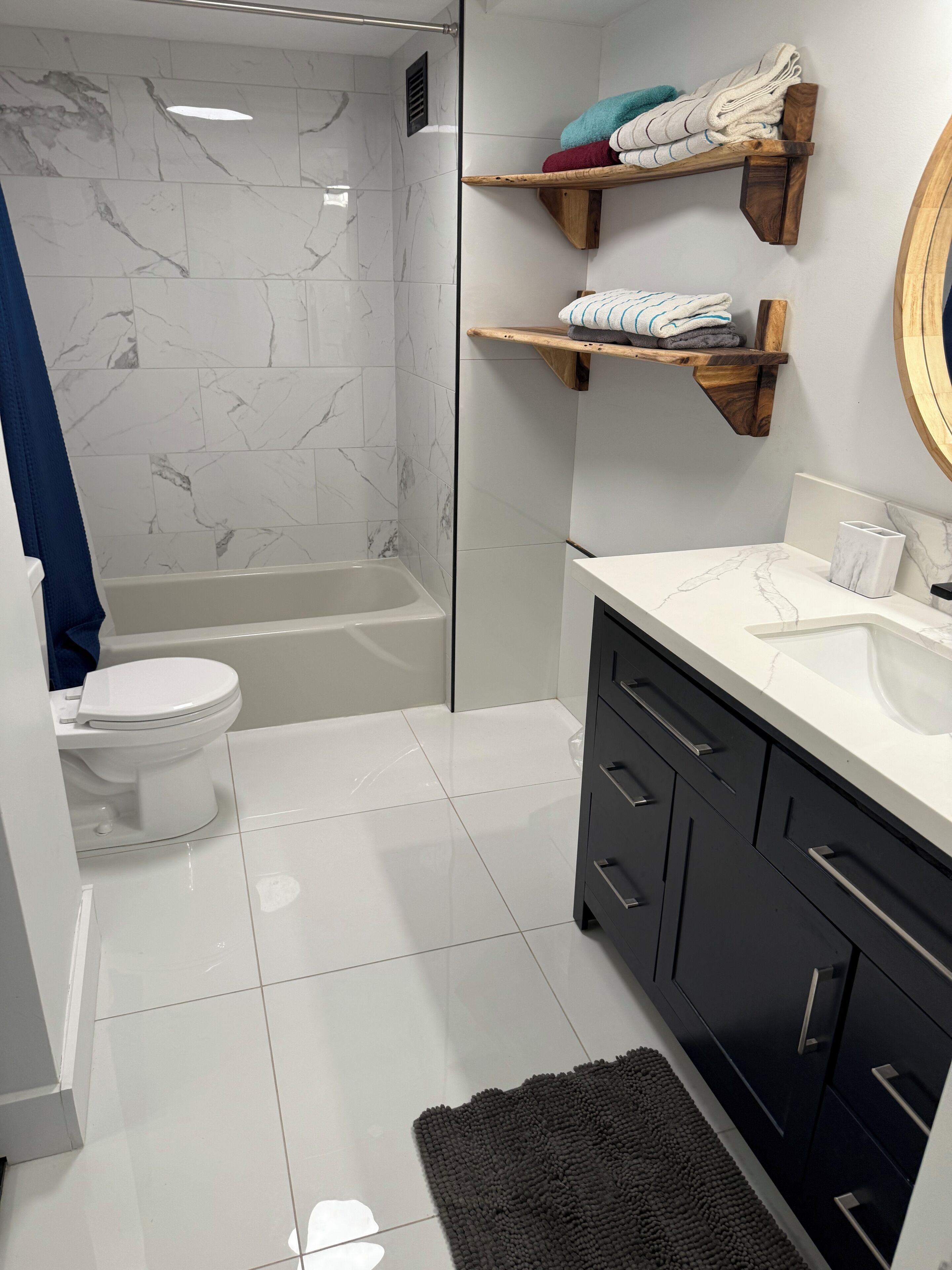 Ein modernes Badezimmer mit Toilette, Badewanne und Waschtisch mit Spiegel.