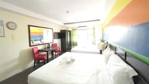 A hotel room with a bed, a desk with a chair, a television, and a wall clock. - Fave Hotel Angeles City formerly Hotel America (Angeles City)