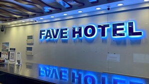 A hotel reception area with a prominent 'FAVE HOTEL' sign in illuminated letters. - Fave Hotel Angeles City formerly Hotel America (Angeles City)